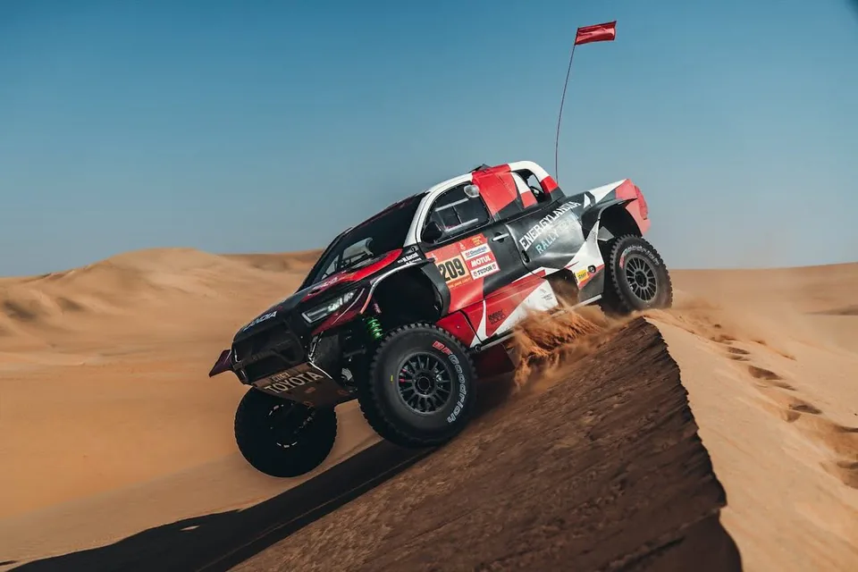 Energylandia Rally Team car on the crest of a dune