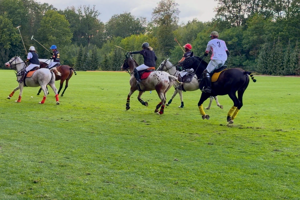 A group of players galloping down the field